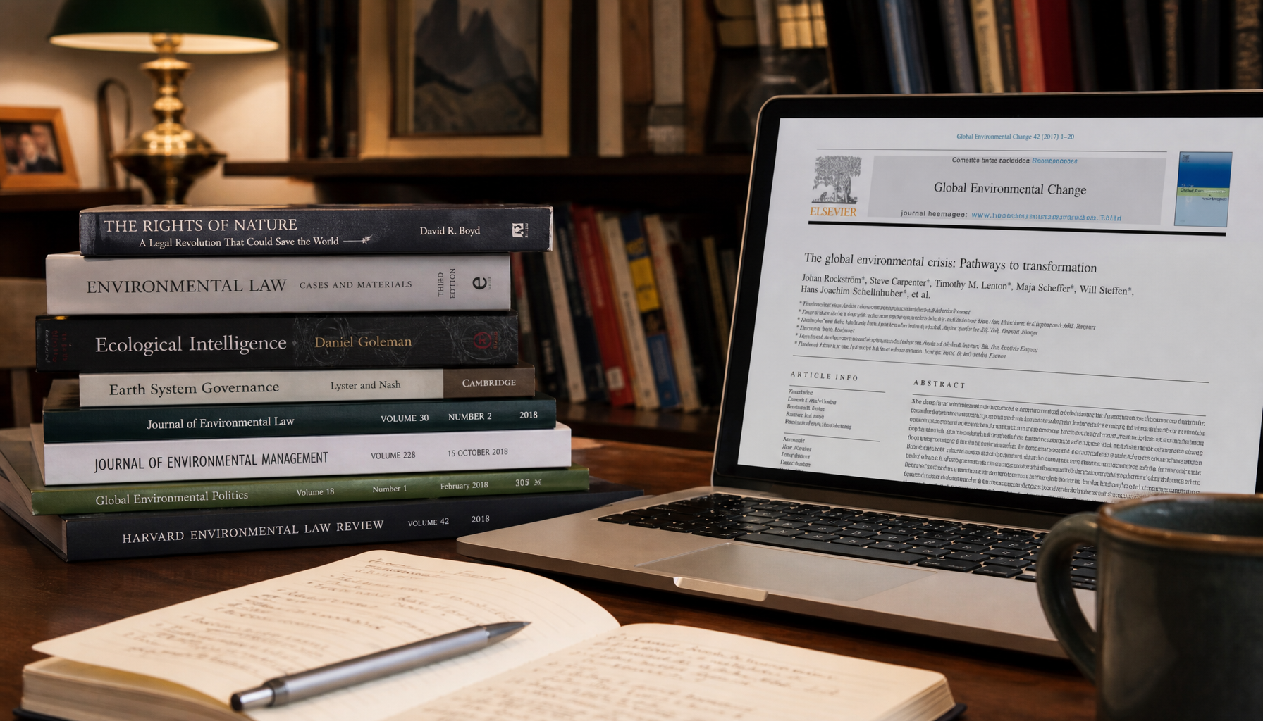 Stack of published books and academic journals next to laptop showing research paper